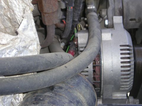 1990 Ford Bronco - This photo shows an alternator and engine hoses, not a 1990 Ford Bronco.