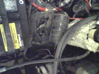 1990 Ford Bronco - Close-up view of an engine bay, a DieHard battery and various engine components.