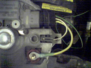 1990 Ford Bronco - Close-up of alternator wiring, showing connections and terminals. Text on yellow labels is visible.