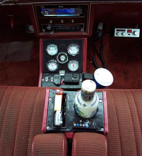 1985 Ford Crown Victoria LTD - Aftermarket gauges and CB radio installed in a car's interior, with a drink bottle on the console.