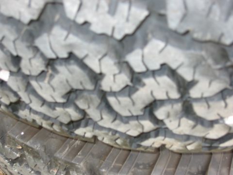 1986 Ford Bronco - The aggressive tread pattern on this tire is visible in the close-up shot.