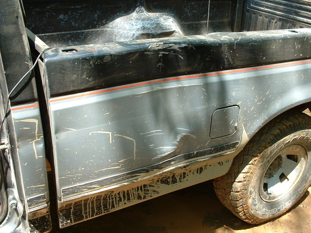 1987 Ford F-150 rear quarter panel and bed, two-tone grey and black with orange stripe