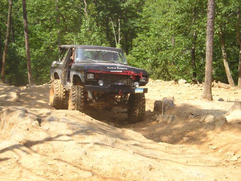 1996 Ford Bronco - This heavily modified 1978 Ford Bronco navigates a challenging rocky trail, its off-road capabilities.
