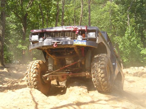 1996 Ford Bronco - This modified 1996 Ford Bronco navigates a challenging off-road course with its large tires and custom front end.