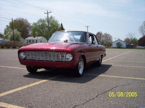 1960 Ford Falcon - Front 3/4 view of a red 1960 Ford Falcon coupe.