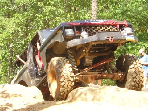 1996 Ford Bronco - This heavily modified off-road vehicle navigates a challenging rocky terrain.
