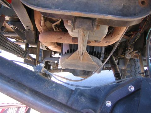 1994 Ford Bronco - The underside of a vehicle reveals its mechanical components, including suspension and drivetrain elements.