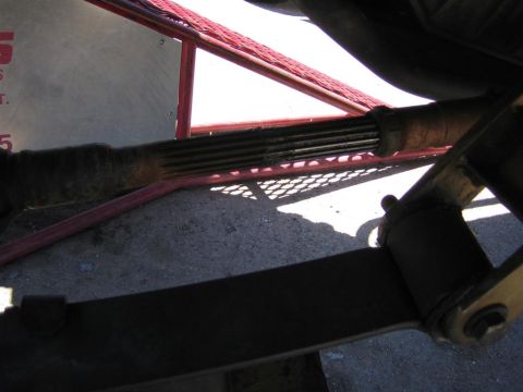 1994 Ford Bronco - Underside view of a vehicle's driveshaft and leaf spring assembly.