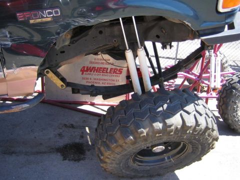 1994 Ford Bronco - This modified Ford Bronco features a lifted suspension with dual shocks and oversized off-road tires.