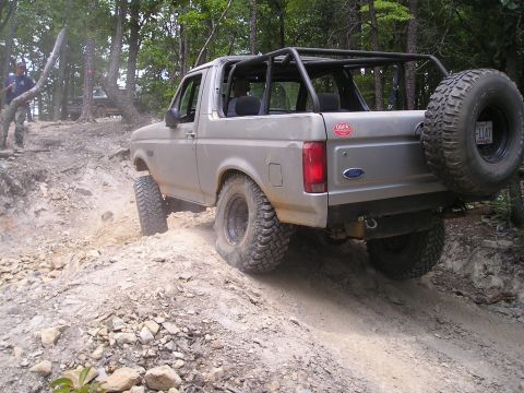 1996 Ford Bronco - This 1996 Ford Bronco is navigating a challenging off-road course with a roll cage installed.