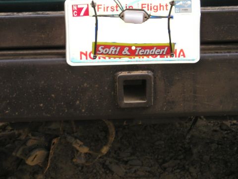 1996 Ford Bronco - A close-up view of a vehicle's rear bumper and license plate, showing a trailer hitch receiver and a North Carolina plate.