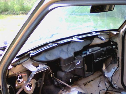 1987 Ford Bronco II - The interior of a vehicle is shown with the dashboard disassembled, revealing internal components and wiring.
