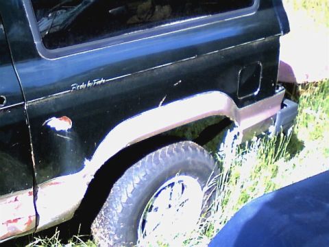 1987 Ford Bronco II - Rear side view of a 1987 Ford Bronco II showing the quarter panel and wheel well.