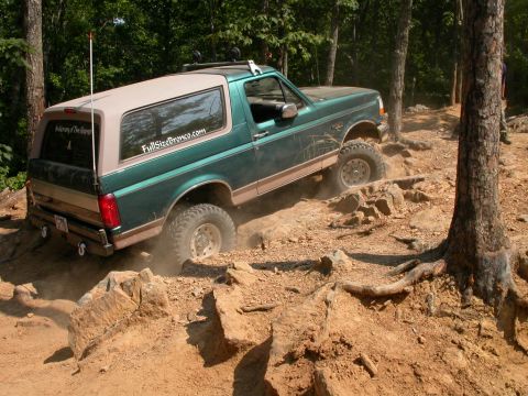 1990 Ford Bronco - This Ford Bronco navigates a challenging off-road course with steep inclines and loose rocks.