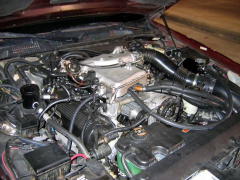 2000 Ford Crown Victoria - Close-up view of the engine compartment, showing various mechanical parts and wiring.