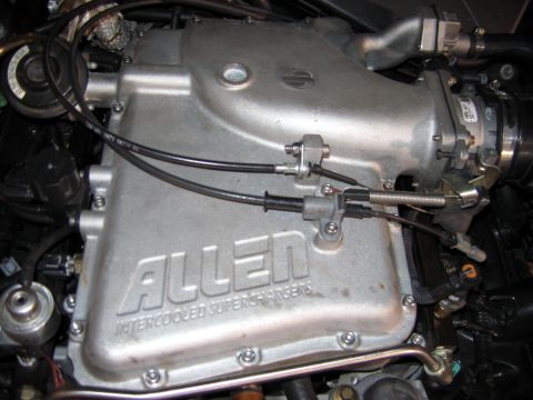 2000 Ford Crown Victoria - Close-up of an Allen intercooled supercharger manifold, showing throttle body and linkage.