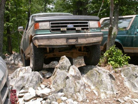 1990 Ford Bronco - This 1990 Ford Bronco is shown off-road, tackling a challenging rock climb.