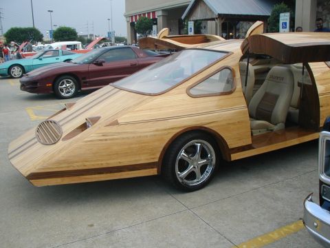 2000 Ford Crown Victoria - A unique car with a wooden exterior and gullwing doors is seen in a parking lot.