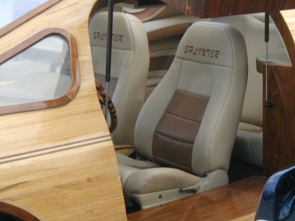 Custom interior with wood paneling, two-tone seats labeled 'SPLINTER', and a wooden steering wheel