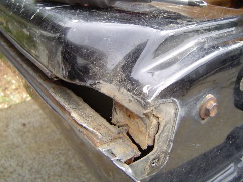 1989 Ford Bronco - Close-up of a damaged tailgate window seal showing significant rust and deterioration.