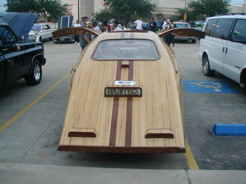 2000 Ford Crown Victoria - This custom vehicle features a unique wooden body with contrasting wood stripes and a "SPLINTER" emblem on the rear.