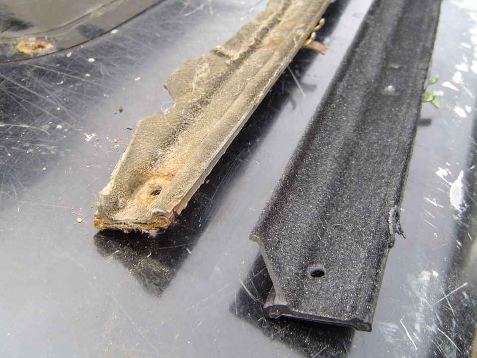 Old rusted weatherstrip seal next to new black rubber replacement seal