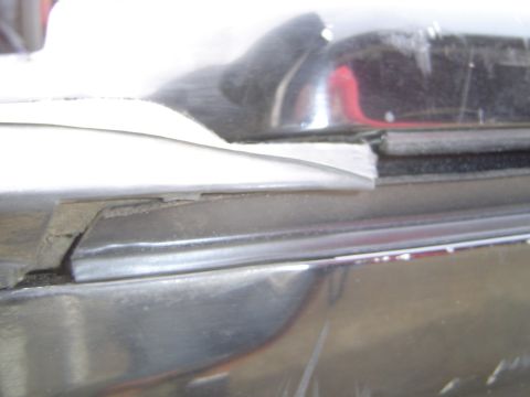 1989 Ford Bronco - Detail of chrome trim and rubber seal, likely from a vehicle's exterior.