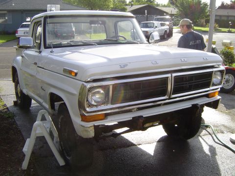1972 Ford F-100 - White 1970 Ford F-100 pickup truck parked in a driveway, supported by jack stands.