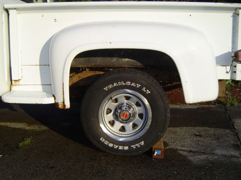 1972 Ford F-100 - Close-up of the rear wheel and fender of a 1972 Ford F-100 pickup truck.