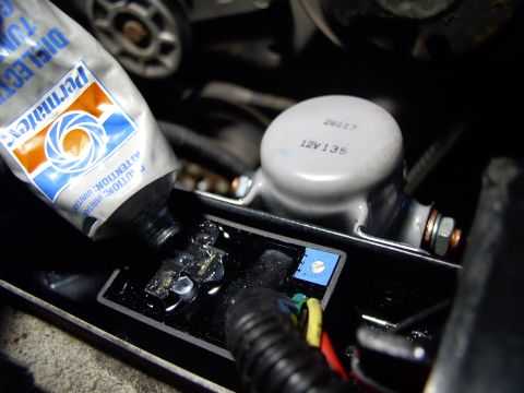 1986 Ford Bronco - Stuffing the relay sockets on the adjustable controller full of dielectric grease. Great shot of adjustable white slot inside the blue squa…