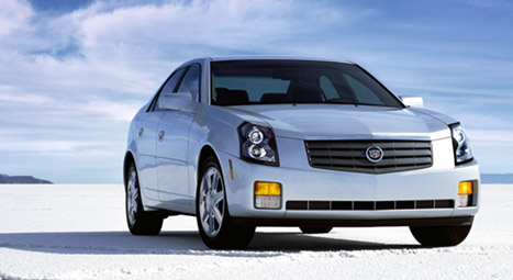 2000 Ford Taurus - A silver Cadillac CTS sedan is shown from the front on a flat, white landscape with a cloudy sky above.
