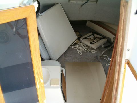 1991 Ford Bronco - The interior of a vehicle appears to be in disarray, with visible damage and scattered debris.