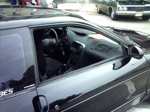 1995 Ford Probe - Interior view of a black 1995 Ford Probe GT, showing the dashboard and driver's side.