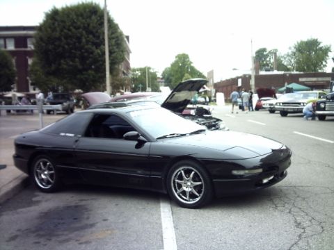 1995 Ford Probe - A black 1995 Ford Probe is parked at an outdoor event with other vehicles visible.