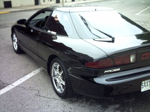 1995 Ford Probe - Rear view of a black 1995 Ford Probe, distinctive honeycomb taillights and a 'PROBE' badge.