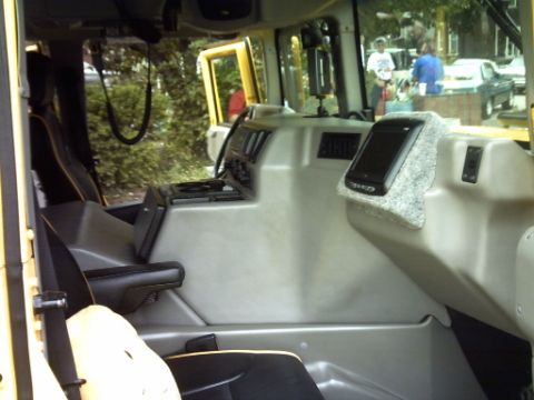 1995 Ford Probe - The interior of a yellow vehicle is shown, with a cell phone placed on the center console.