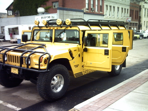 Yellow Hummer H1, 3q-front view, doors open, with smiley face lights