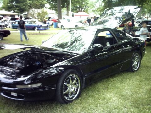 1995 Ford Probe - A black 1995 Ford Probe is displayed with its hoods open at an outdoor car show.