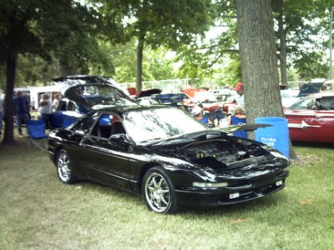 1995 Ford Probe - A black 1995 Ford Probe is displayed with its hood open at an outdoor event.