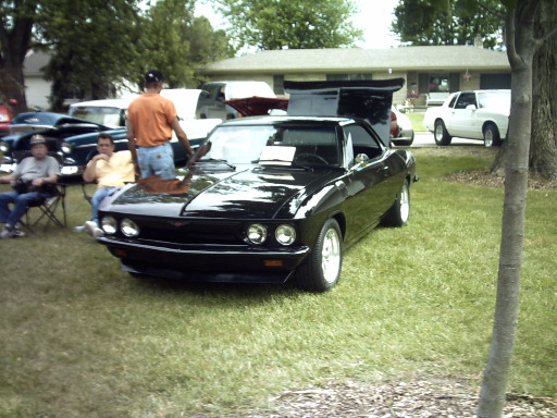 Black coupe with hood open, front view