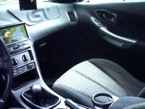 1995 Ford Probe - The interior of a car is shown, a GPS unit and a textured seat.