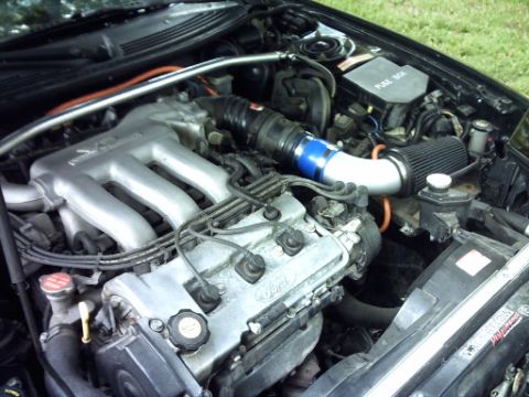 1995 Ford Probe - The engine bay of a 1995 Ford Probe is shown with a custom air intake system installed.