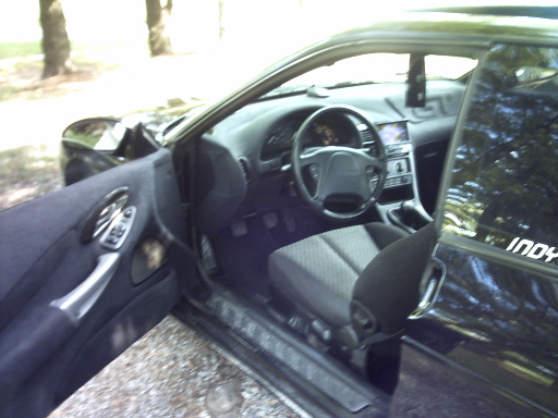 Interior of black car with "INDY" sticker on window