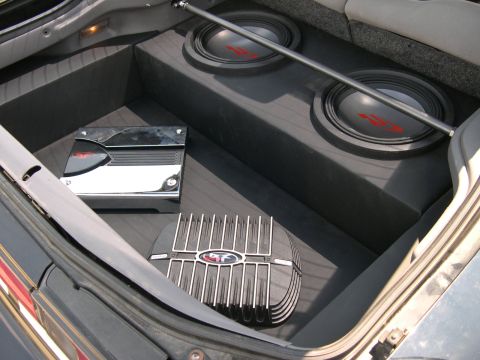 1997 Ford Probe - Finished car-audio install in a carpeted hatch area: two Alpine Type-R subwoofers in a black-carpeted box along the back wall, with a chrom…