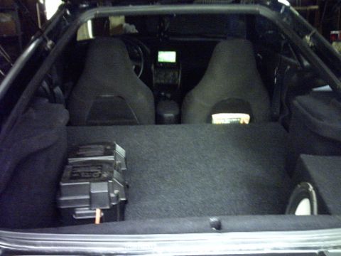 1995 Ford Probe - View of the car's interior, including the seats, dashboard, and cargo space with a fuse box visible.
