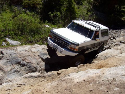 1979 Ford Bronco - This SUV is shown off-roading on a challenging rocky path.