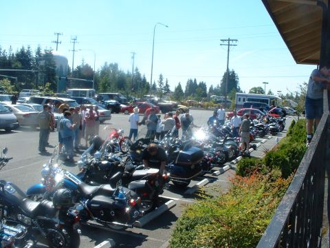 1999 Ford Crown Victoria - A group of people gathered around parked motorcycles during an outdoor event.