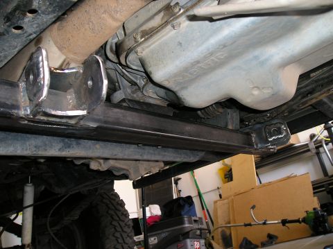 1993 Ford Bronco - Custom suspension modifications are visible on the underbody of this vehicle, with a tire and shock absorber in view.