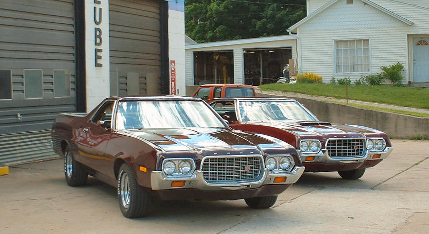 Two brown 1972 Ford Rancheros parked in front of a garage