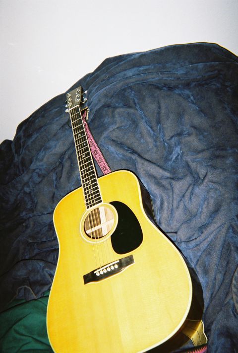 1972 Ford Ranchero - An acoustic guitar is positioned against a textured blue blanket, with its headstock visible at the top.